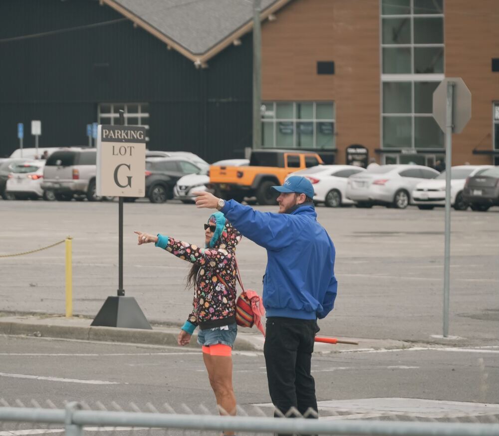 Marin Valet attendant directing vehicles at a busy event lot